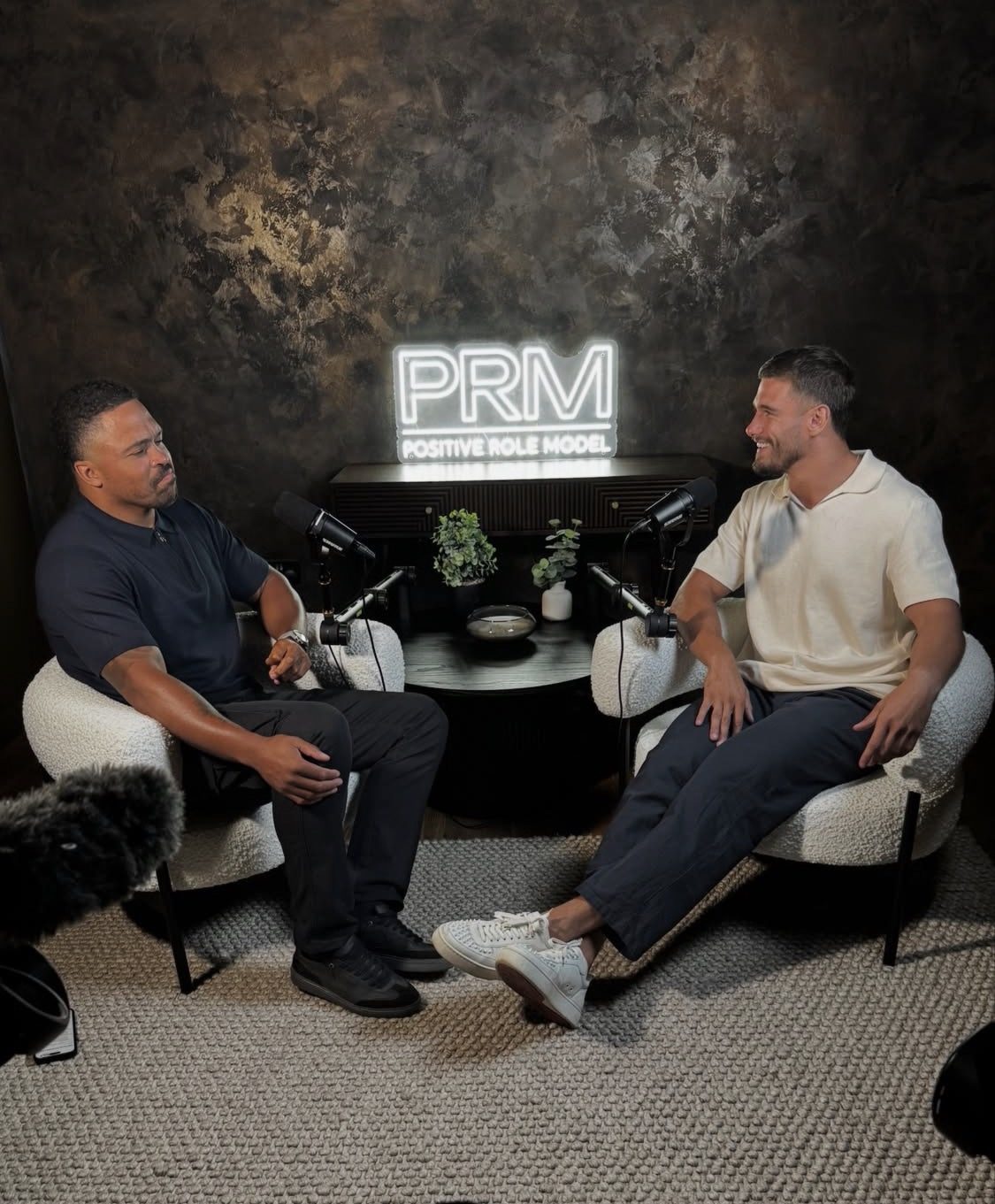 Two guests in conversation on the PRM podcast set